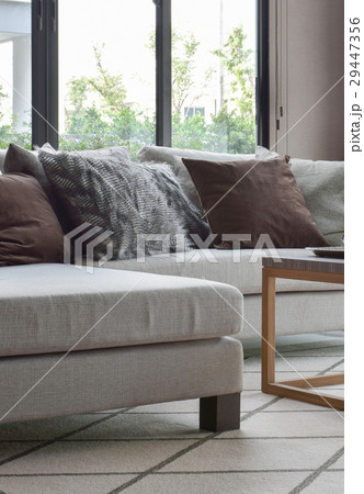 Brown and gray pillows on sofa in living room 29447356