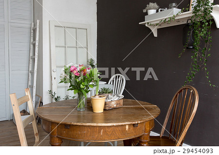 Interior furnished with chair, table with flowers 29454093