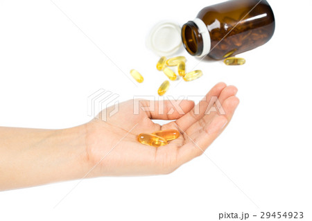 Woman's hand holding Fish oil capsules Woman's hand holding Fish oil capsules 29454923