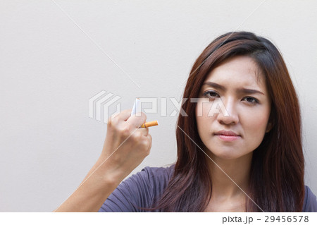 woman quits smoking, destroying cigarette woman quits smoking, destroying cigarette 29456578