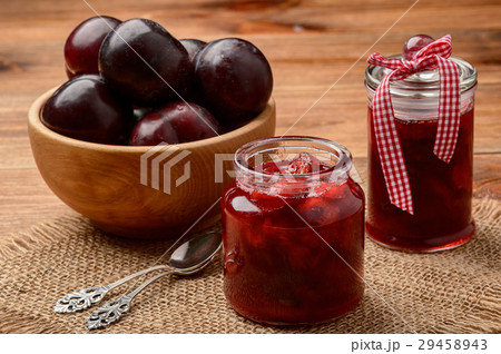 Plum jam in glass jars on wooden background. Plum jam in glass jars on wooden background. 29458943