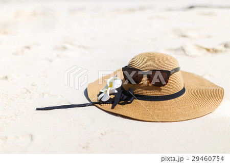 Glasses and a hat with frangipani flower. Glasses and a hat with frangipani flower. 29460754