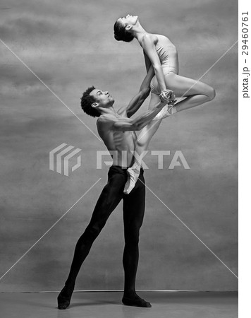 Couple of ballet dancers posing over gray Couple of ballet dancers posing over gray 29460761