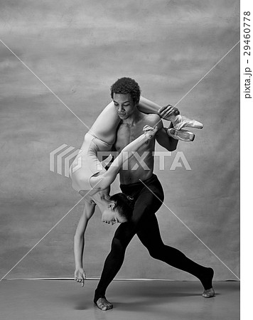 Couple of ballet dancers posing over gray Couple of ballet dancers posing over gray 29460778