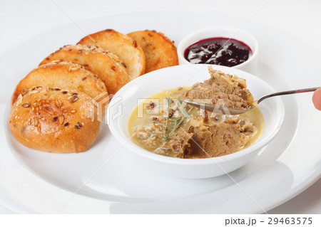 Pate for sandwiches on a spoon holds a hand on a 29463575