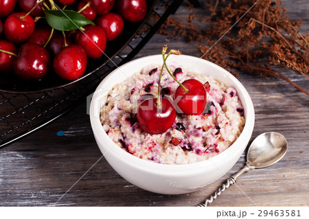 oatmeal porridge with cherry still life on a black 29463581