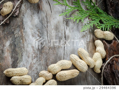 Raw peanuts scattered on aged wood 29464396