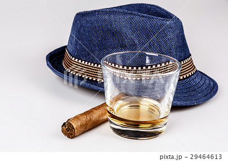 blue hat with cigar and expensive drink of whisky  29464613