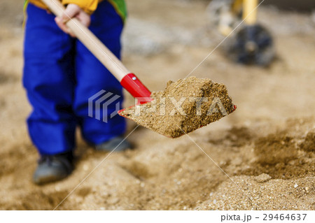 child play with sand and red shovel child play with sand and red shovel 29464637
