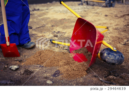 child play with sand, red shovel and small cute child play with sand, red shovel and small cute 29464639