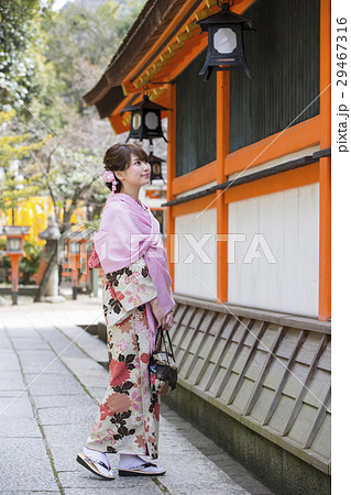 京都府京都市東山区祇園町の八坂神社の境内を散策する着物姿の笑顔の若い女性 29467316