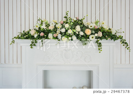 Bouquet of flowers over white fireplace in classic 29467378
