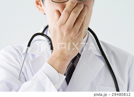 口を隠す男性医師の写真素材
