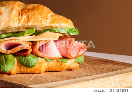 Croissants sandwiches on the wooden cutting board Croissants sandwiches on the wooden cutting board 29482653