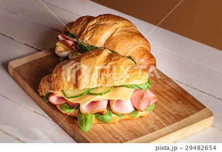 Croissants sandwiches on the wooden cutting board Croissants sandwiches on the wooden cutting board 29482654
