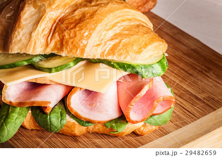 Croissants sandwiches on the wooden cutting board 29482659