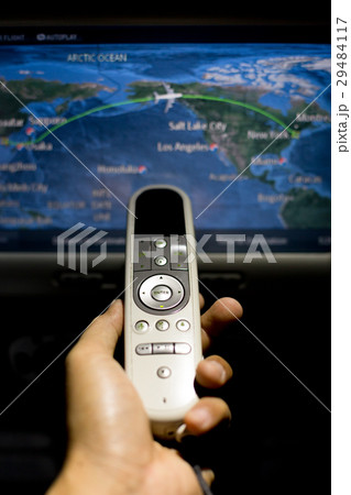 Hand holding remote control on airplane Hand holding remote control on airplane 29484117