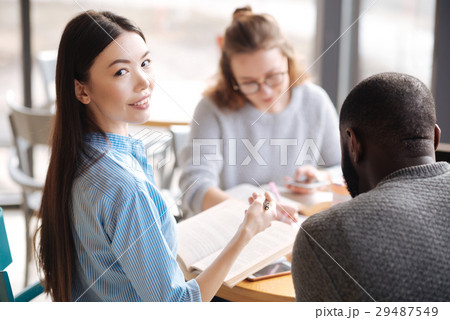 Happy female student studying with her fellows Happy female student studying with her fellows 29487549