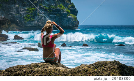 Girl sitting on the Rock and watching Huge Waves Girl sitting on the Rock and watching Huge Waves 29488800