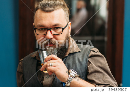 Bearded man drinking whiskey portrait 29489507