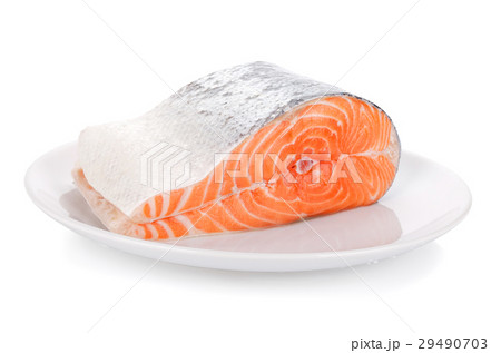 Raw steak of salmon on white plate isolated 29490703