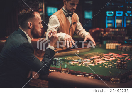 Upper class man gambling in a casino 29499232