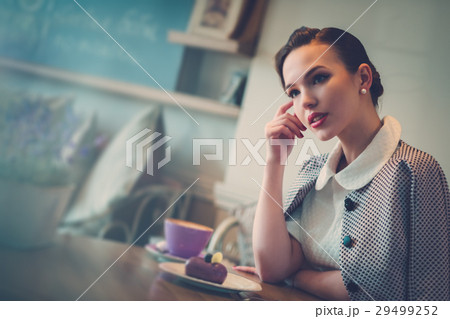 Elegant young lady alone in a cafe Elegant young lady alone in a cafe 29499252