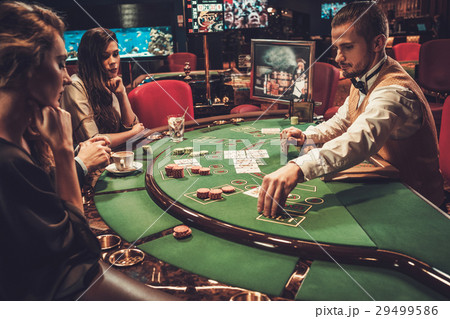 Upper class friends gambling in a casino Upper class friends gambling in a casino 29499586