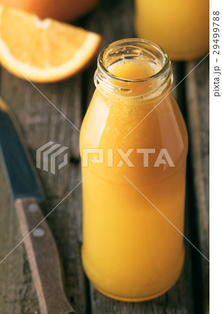 Close-up of bottle of fresh orange juice Close-up of bottle of fresh orange juice 29499788