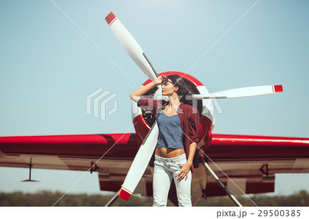 Woman pilot and airplane 29500385