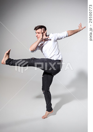 The young man dancing on gray 29500773