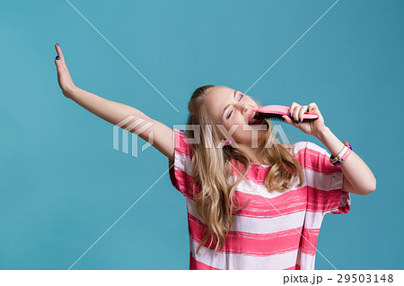 young funny blond woman sings using pink hairbrush young funny blond woman sings using pink hairbrush 29503148