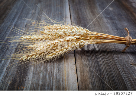 Sheaf of wheat ears on the wooden. Sheaf of wheat ears on the wooden. 29507227