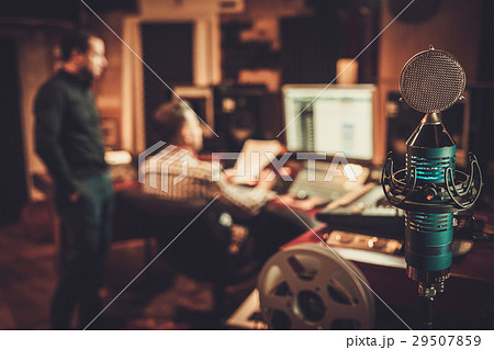 Guys working in boutique recording studio 29507859