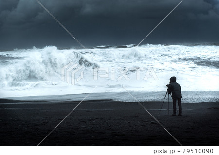 Photographer on black sand beach 29510090