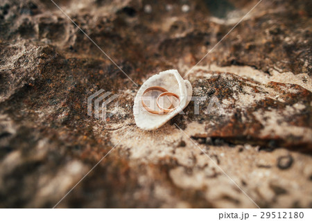 wedding rings on beach 29512180