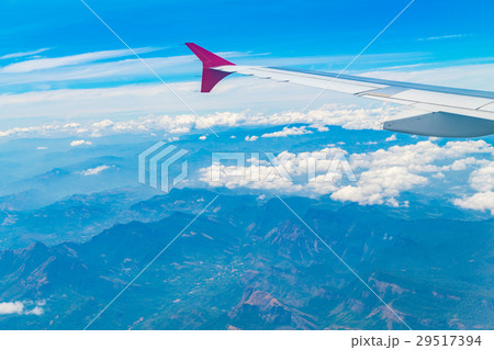 Wing of an airplane flying above the clouds . 29517394