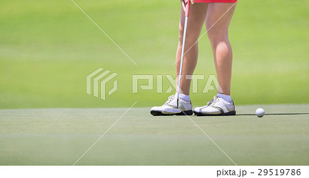 Female golfer putting on green. Female golfer putting on green. 29519786