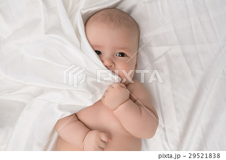 Baby boy lying on white linen studio shot 29521838