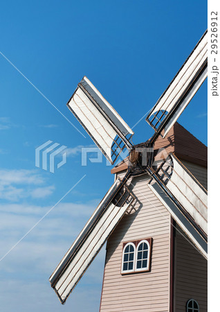 Wooden windmill on blue sky background 29526912