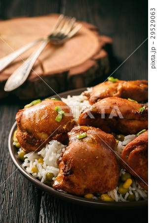 Chicken pieces baked in tomato sauce. 29529063