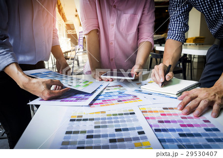 Designers Working Together At Desks In Modern Office 29530407