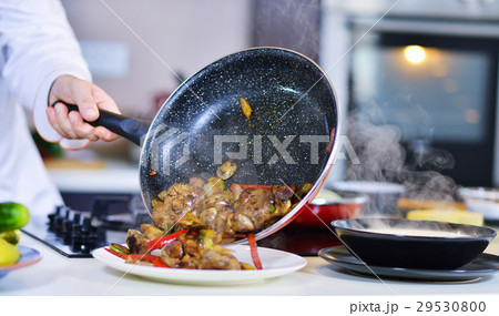 mature chef preparing a meal with various 29530800