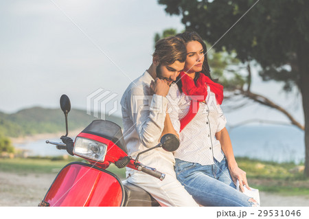 Portrait of happy young love couple on scooter 29531046