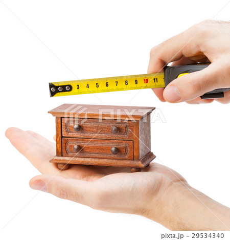 woodworker measuring chest of drawers  29534340