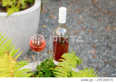 One glass and bottle of red or rose wine in 29536870