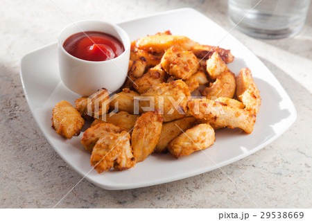 Fried chicken fillet with ketchup on a white plate Fried chicken fillet with ketchup on a white plate 29538669
