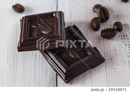 Pieces of chocolate and a coffee beans 29538671