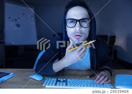 Handsome serious man holding his chin Handsome serious man holding his chin 29539404