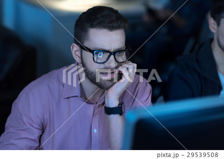 Thoughtful intelligent programmer concentrating on 29539508